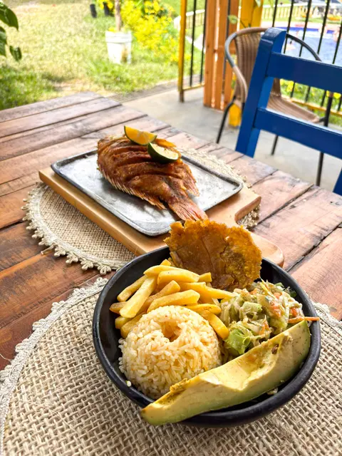 Platos típicos con pescado, arroz, ensalada, papas y aguacate